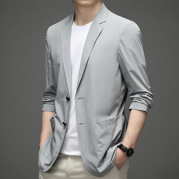 a man wearing a gray jacket and white shirt
