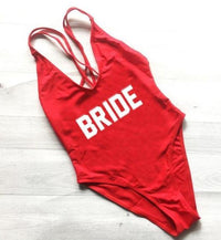 a red swimsuit with the word bride printed on it
