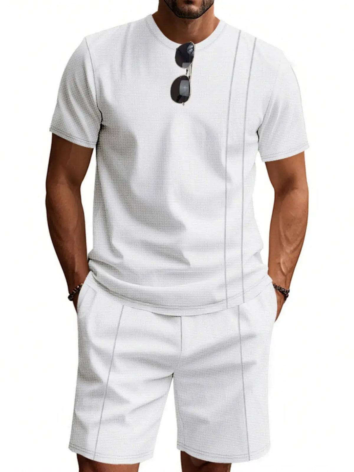Men's white round neck short sleeve top and shorts set, featuring pockets and slightly stretchy fabric.