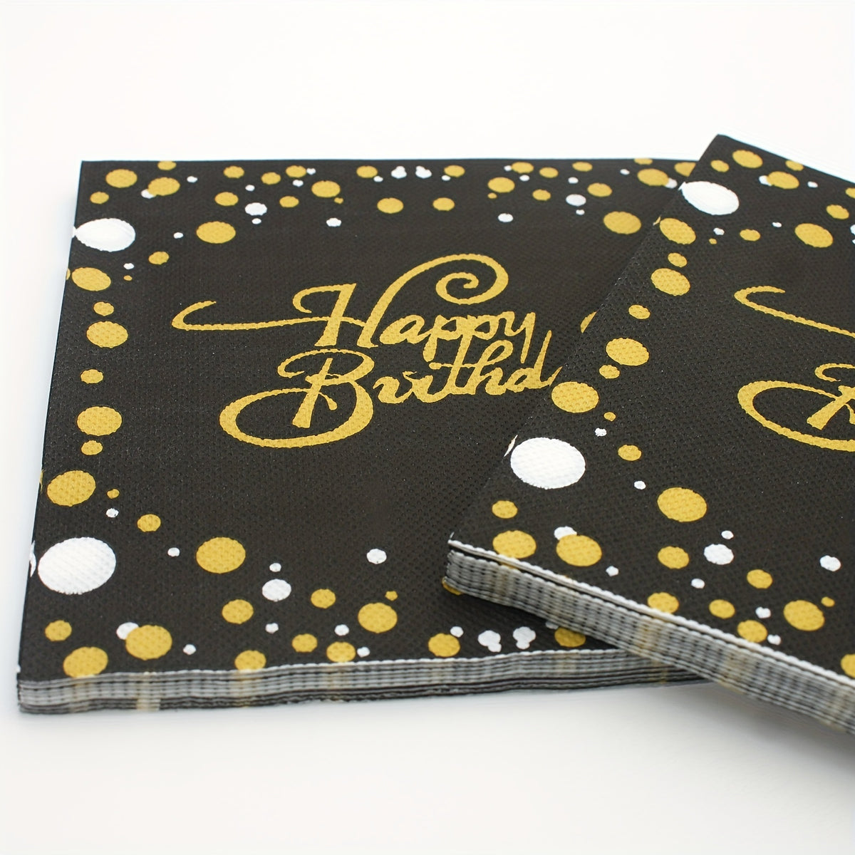 a pair of black and gold birthday napkins