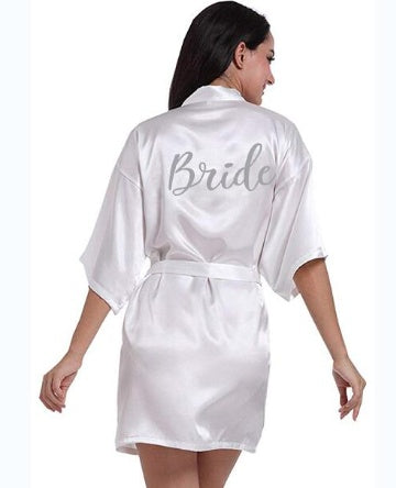 a woman in a white robe with the word bride on it