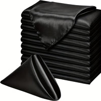 a stack of black sheets and a black pillow