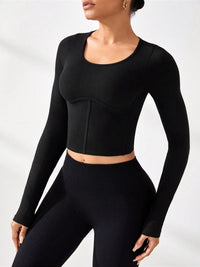 Model wearing a black round neck long sleeve active t-shirt with matching leggings, showcasing affordable activewear.