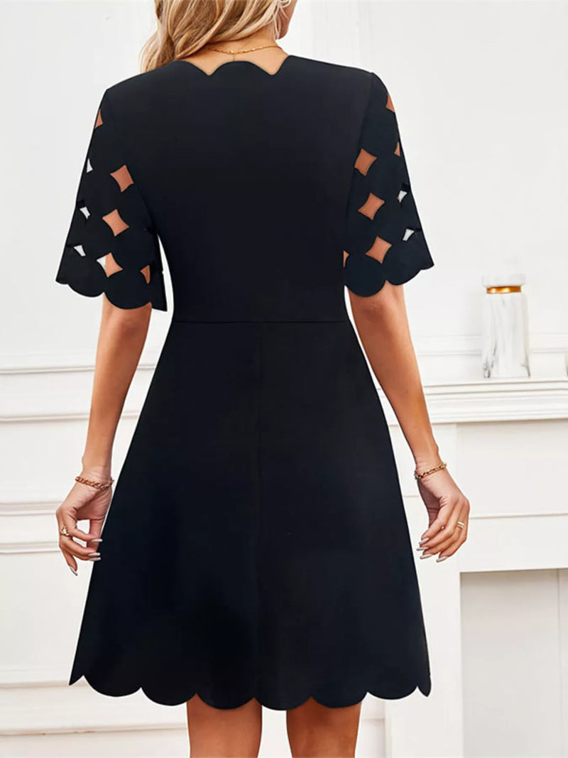 Back view of a Cutout Half Sleeve Mini Dress in black, featuring scalloped hem and stylish cutout sleeves.
