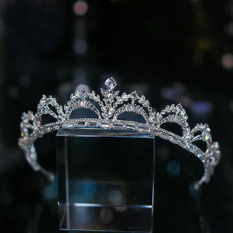 a tiara on display on a black surface