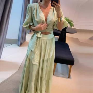 a woman taking a selfie in a green dress