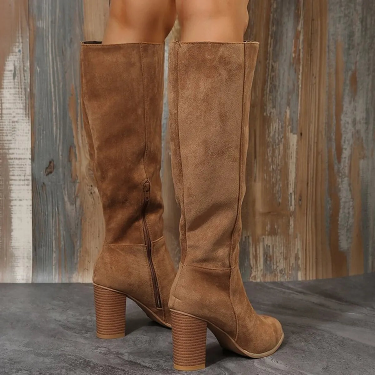 Point toe block heel boots in brown suede with a high heel and zipper detail, showcasing a stylish back view.