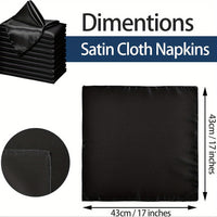 a pile of black satin cloth next to a pile of black satin cloth