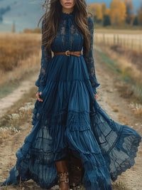 Lace Long Sleeve Maxi Dress in dark blue with layered skirt, worn with a belt, set in a rustic outdoor location.