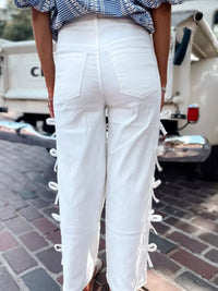 Back view of Bow-Accented Wide-Leg Pants featuring white fabric with stylish bows on the sides.