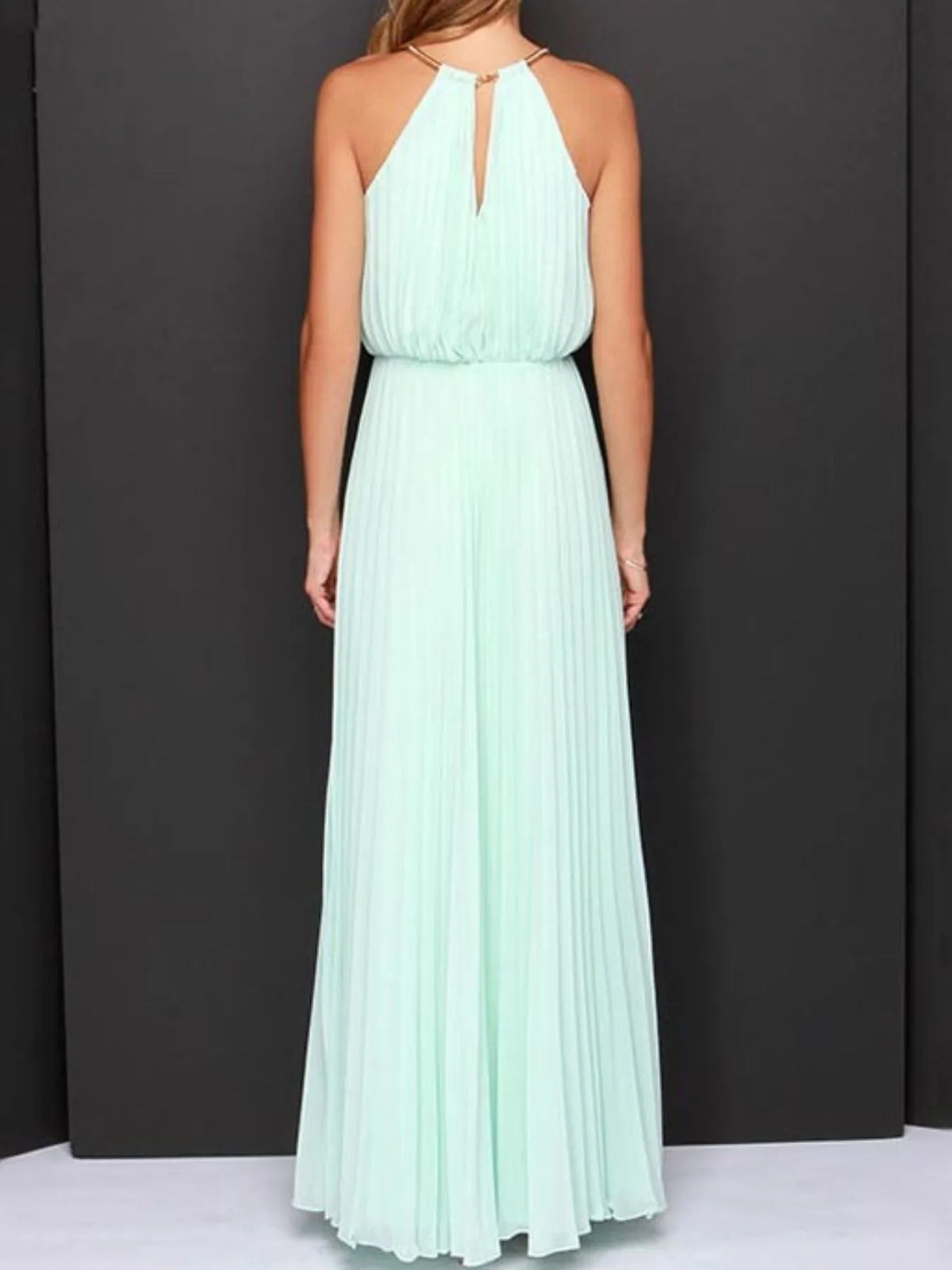 Back view of a pleated sleeveless maxi tank dress in mint green, showcasing its elegant design and flowing fabric.