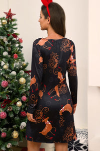 Full Size Christmas Long Sleeve Dress featuring reindeer print, back view, model in festive setting with Christmas tree.