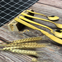 a bunch of yellow utensils sitting on top of a wooden table