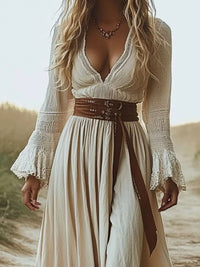 Model wearing Full Size Deep-V Neck Long Sleeve Maxi Dress Plus Size with lace detail and a belt in a scenic outdoor setting.