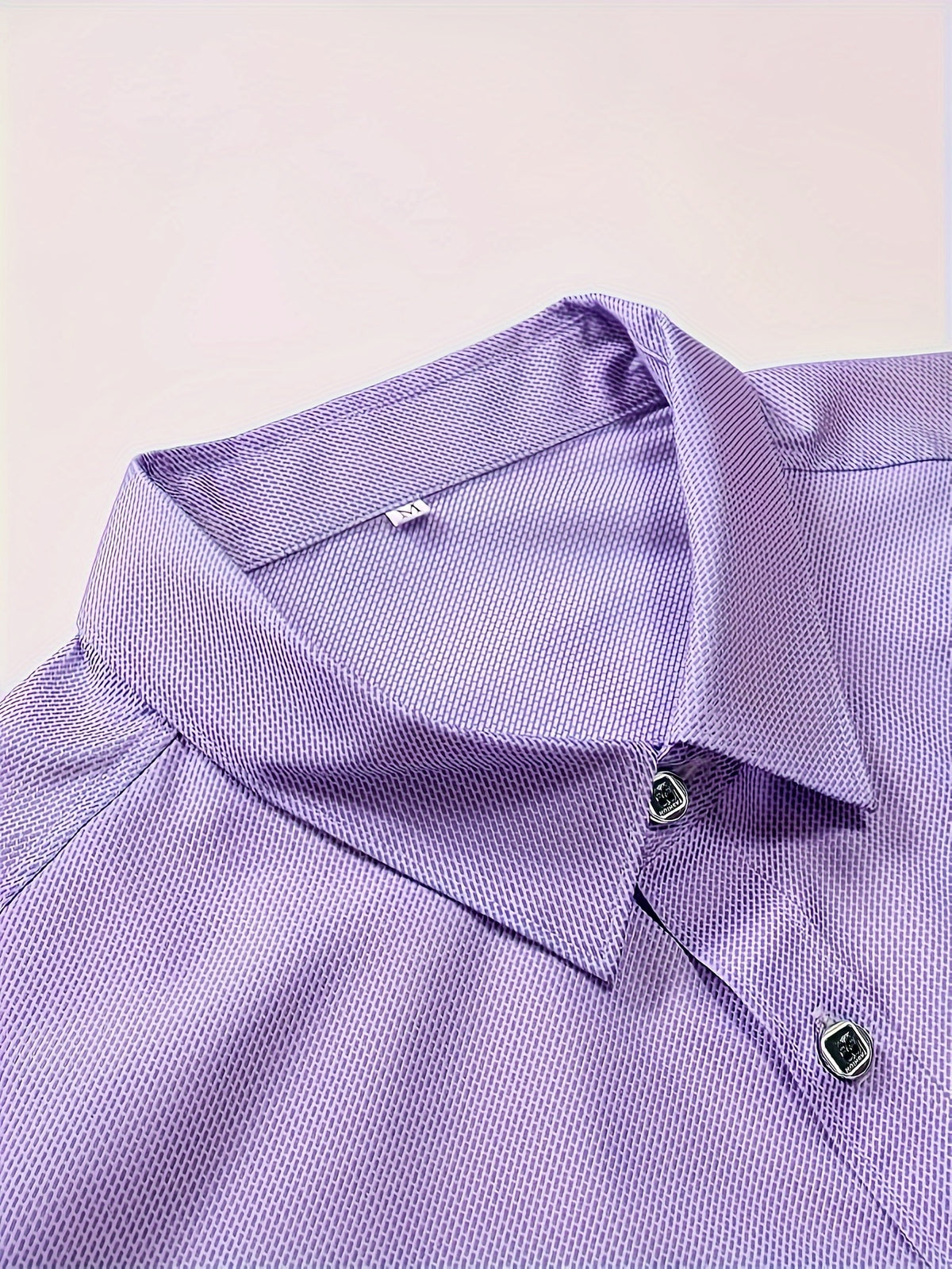 a close up of a purple shirt on a white background