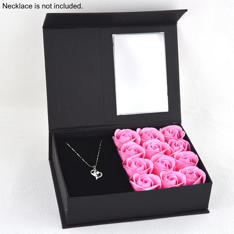 a black box with pink roses inside of it