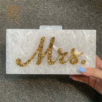 Luxurious white marble evening bag with 'Mrs.' in gold, perfect for weddings and bridal parties.