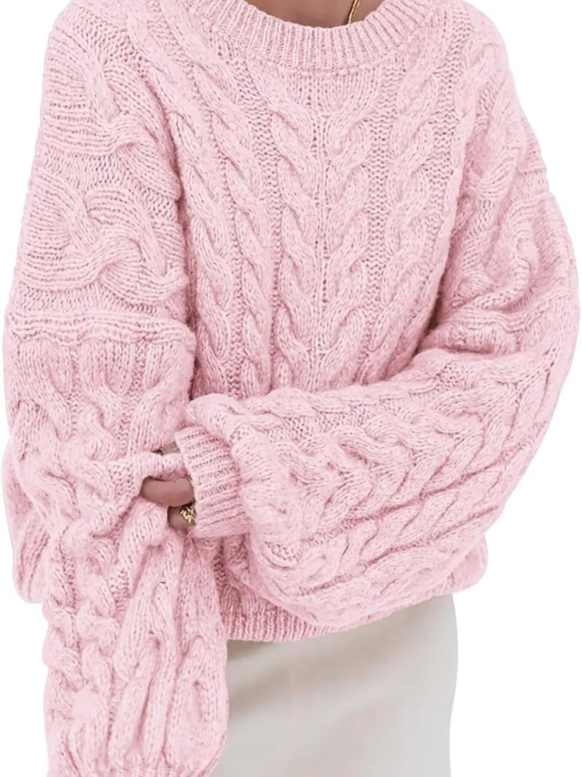 Light pink cable knit long sleeve sweater with oversized sleeves for cozy style.
