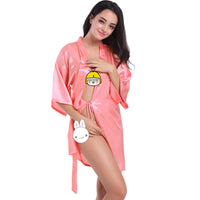 a woman in a pink bathrobe posing for a picture