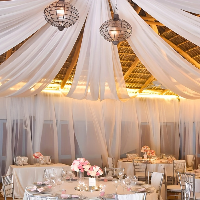 a banquet hall with white drapes and tables