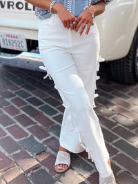 Woman wearing Bow-Accented Wide-Leg Pants in white, featuring decorative bows on the sides.