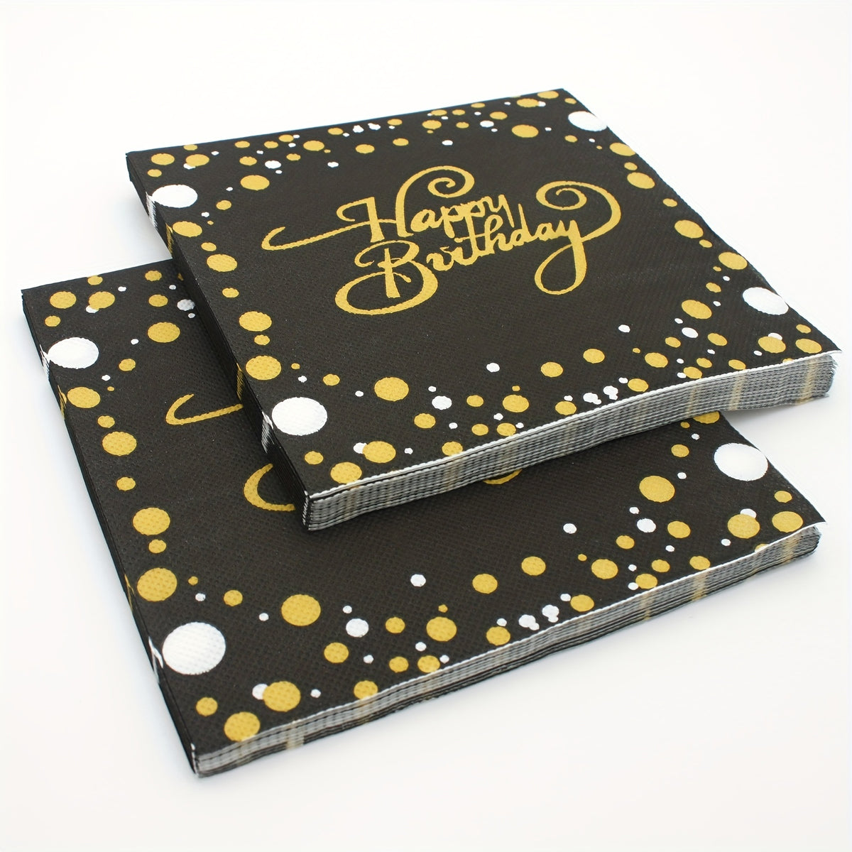 a black and yellow birthday cake with polka dots