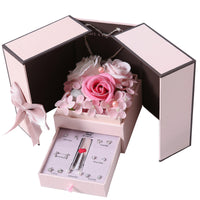 a pink box with a pink rose and a pink pen in it