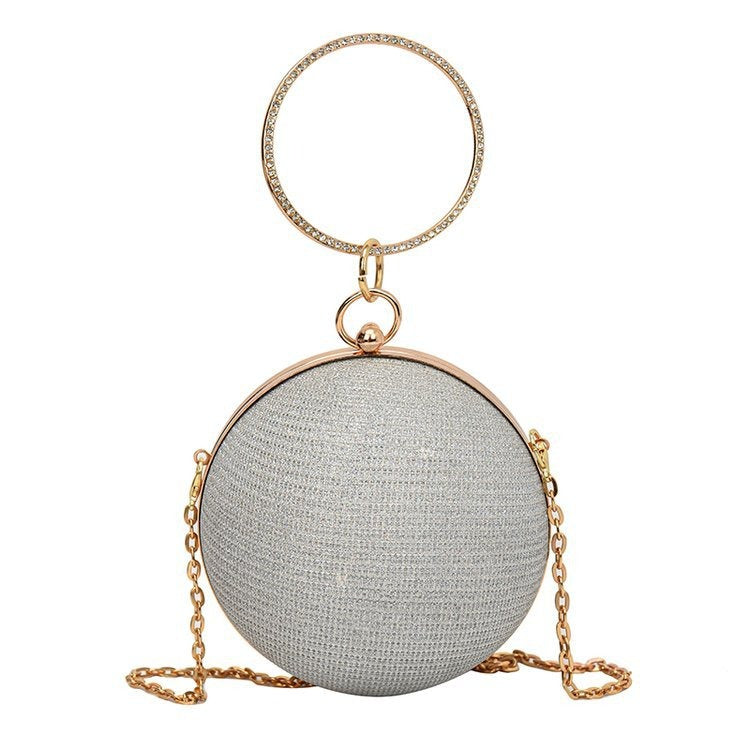 Luxurious spherical handbag in silver with gold chain, perfect for elegant weddings and special occasions.