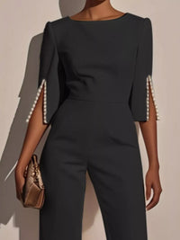 Wide-Leg Jumpsuit with Slit Sleeve featuring pearl details on sleeves and a chic design.