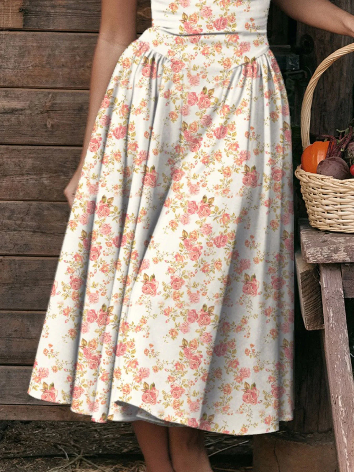 Floral print skirt with a full silhouette, featuring pink and orange flowers on a white background, styled casually.