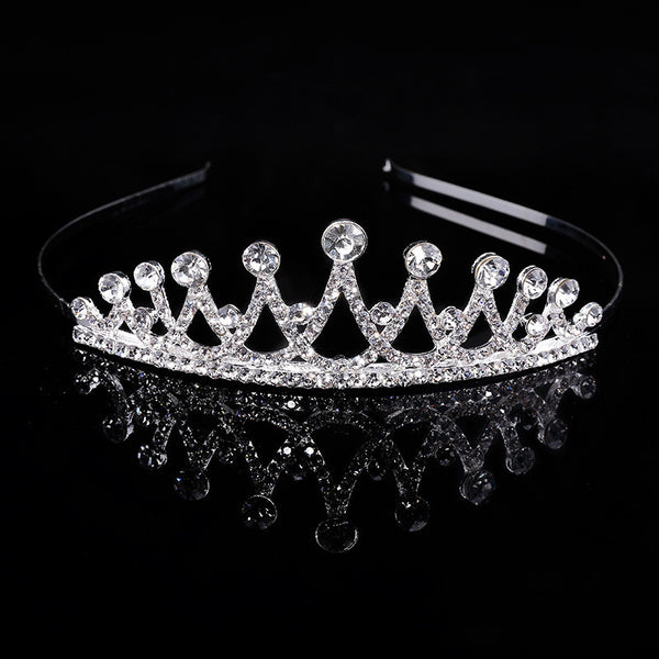 a tiara with crystal stones on a black background