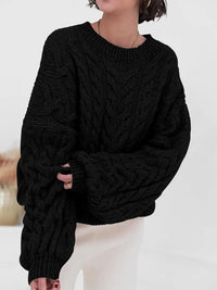 Black cable knit long sleeve sweater featuring a relaxed fit and cozy texture, perfect for casual style.
