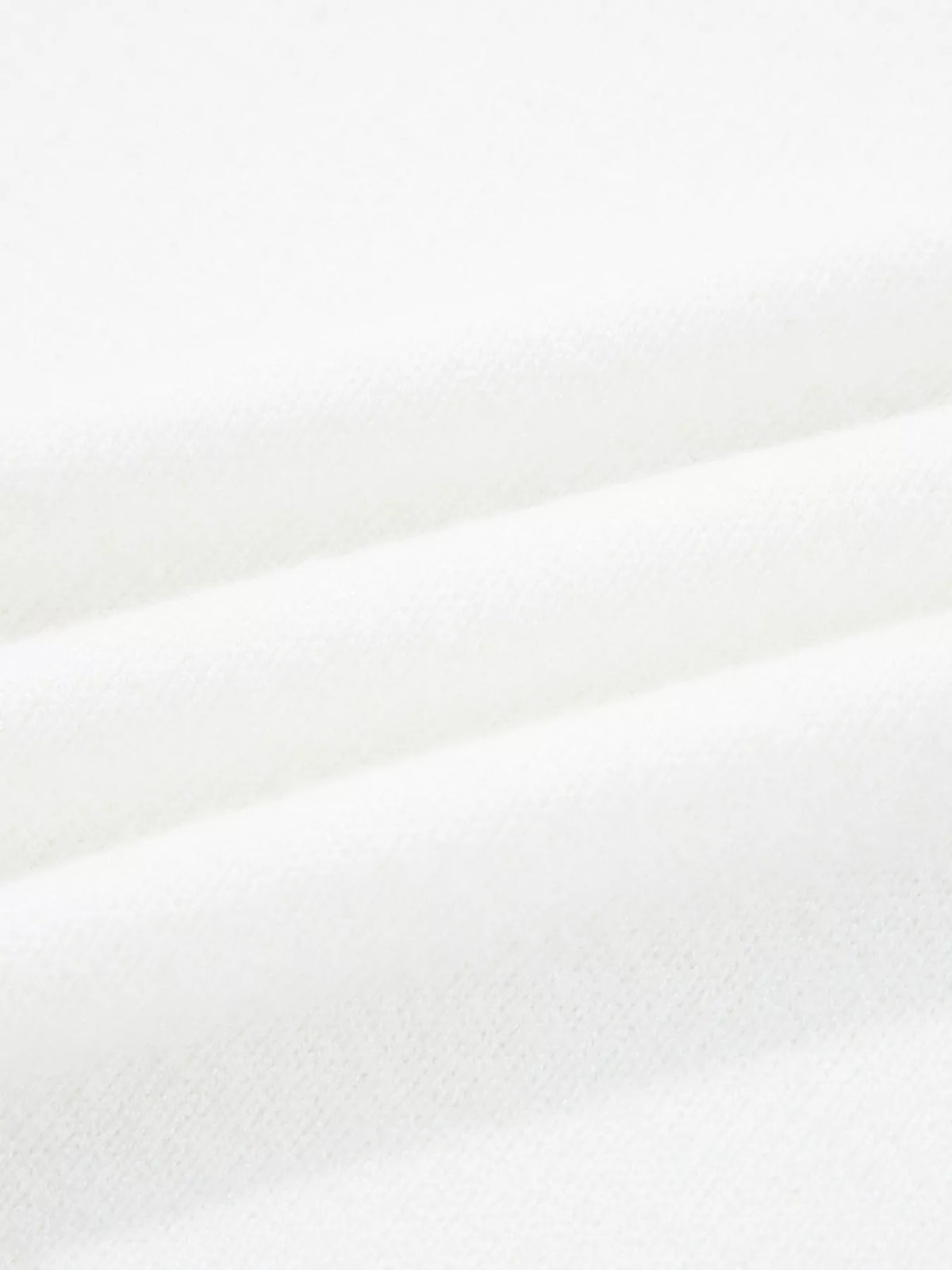 Close-up of soft white fabric showcasing texture of MERRY Letter Pattern Christmas Raglan Sleeve Sweater.