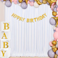 a baby shower with balloons and a happy birthday sign