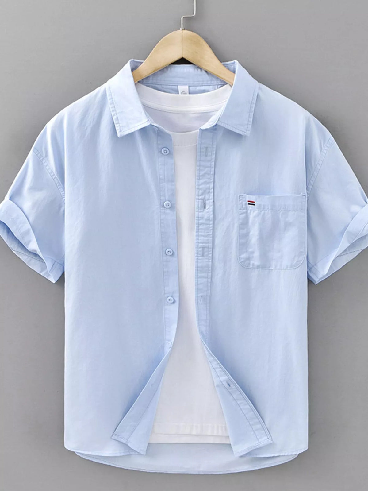 Men's plus size plaid button-up short sleeve shirt in light blue with pocket detail.
