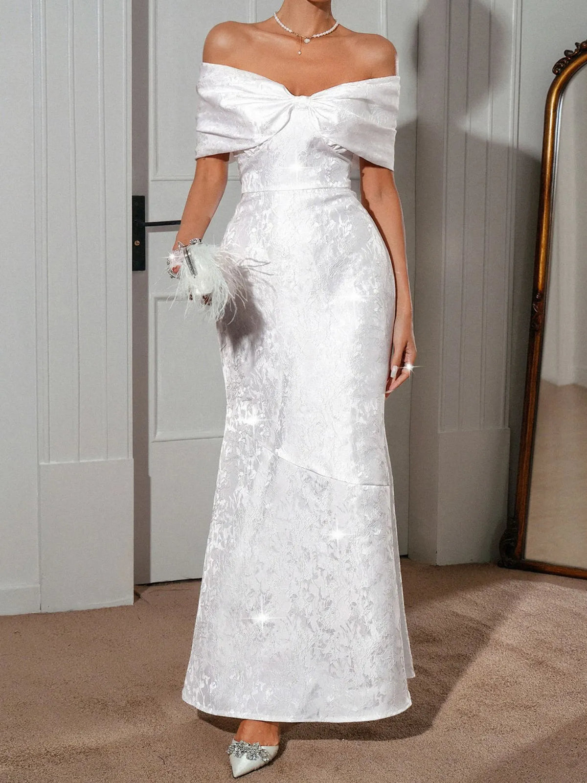 Elegant off-shoulder maxi dress in white with lace-up detailing and fitted silhouette, perfect for special occasions.