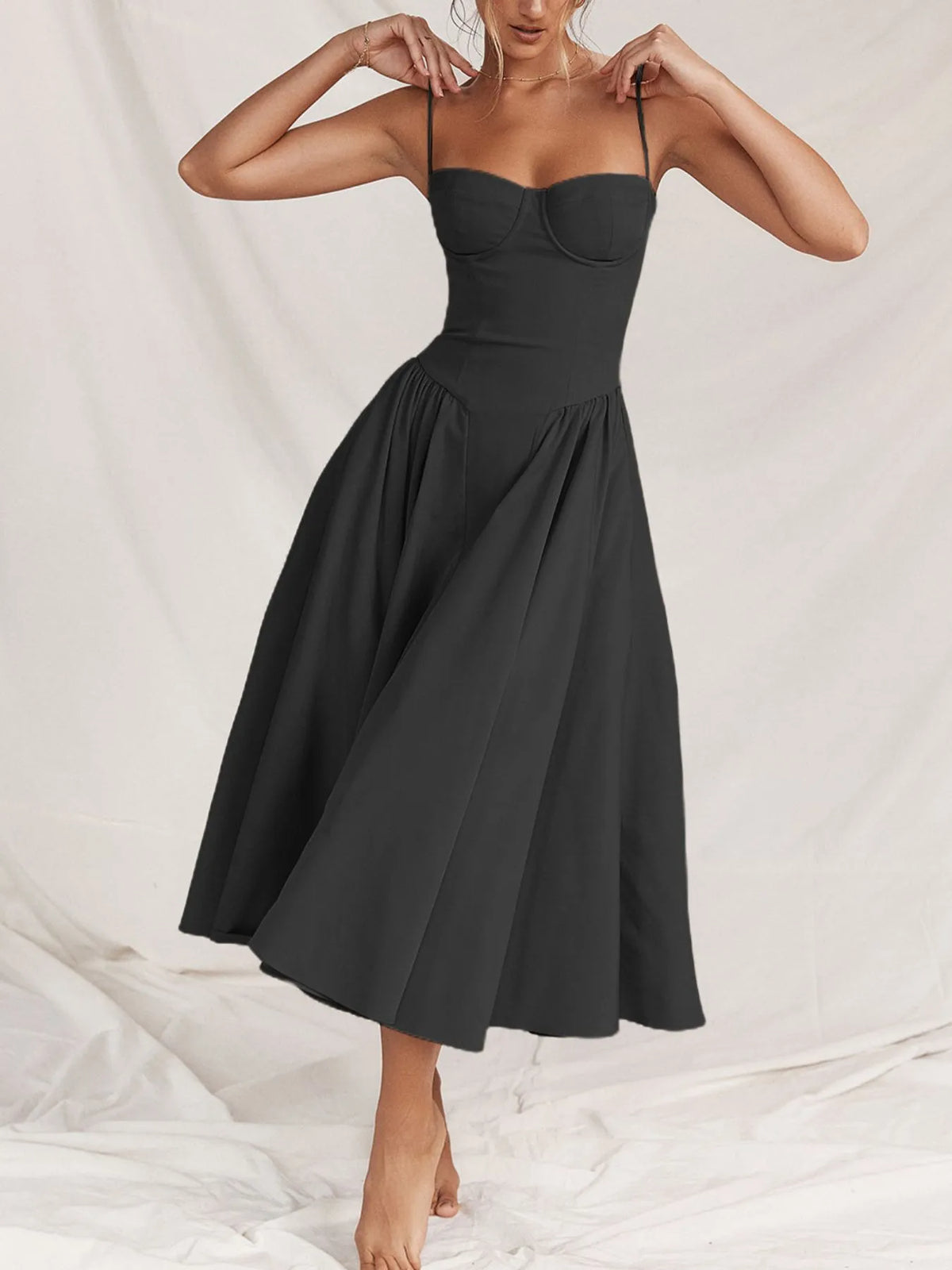 Ruched sweetheart neck cami dress in black with a flowy skirt, perfect for casual or formal occasions.