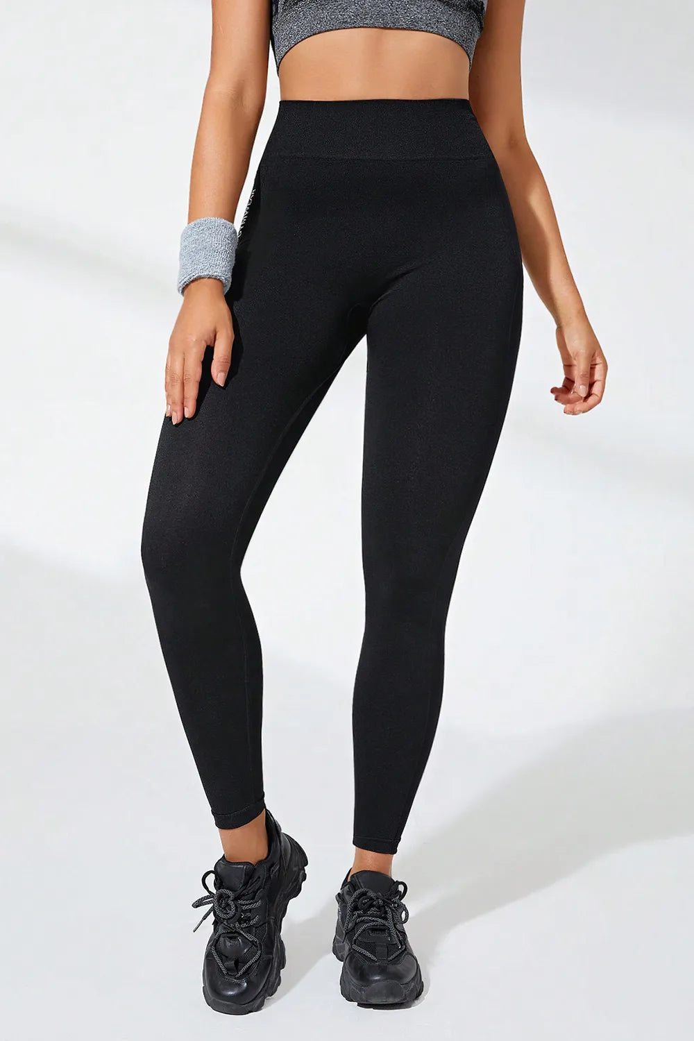 High waist black active leggings featuring a stretchy material, perfect for workouts and casual wear.