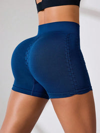 Side view of high rise active shorts showcasing ruched design and stretchy material in navy blue.
