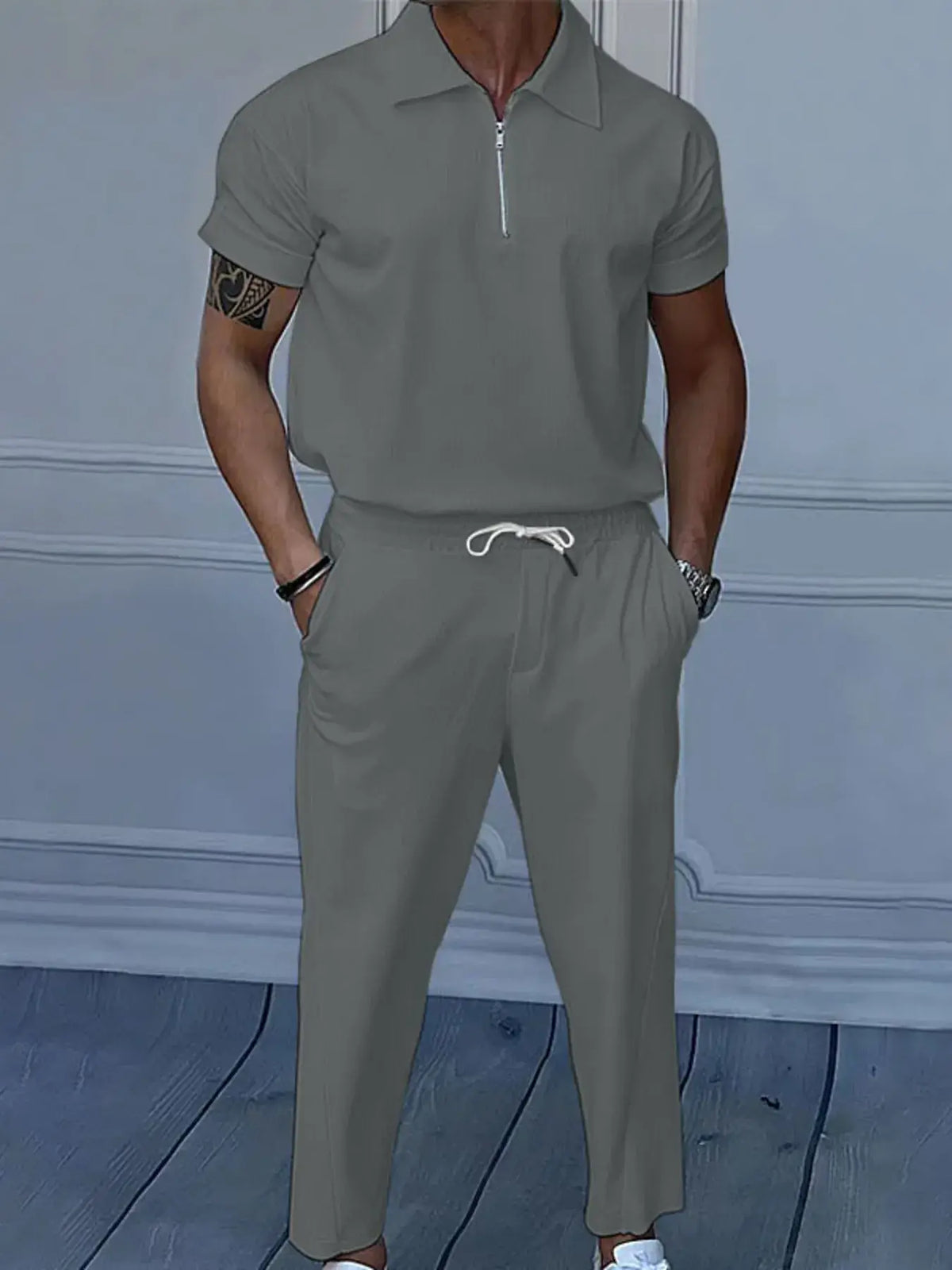 Men's gray quarter zip short sleeve polo and pants set, featuring drawstring and pockets, perfect for casual or formal wear in NZ.