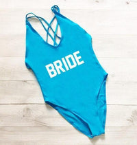 a bride swimsuit on a wooden floor