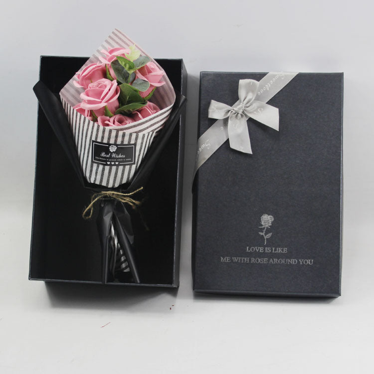 a bouquet of pink roses in a black box