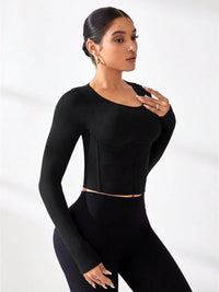 Model wearing a black round neck long sleeve active t-shirt, showcasing a sleek and stylish athletic look.