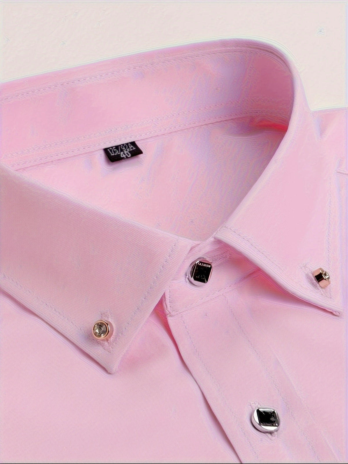 a close up of a pink shirt on a white background