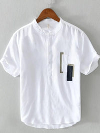 Men's plus size geometric contrast half button t-shirt in white, featuring unique pocket details, perfect for casual wear.