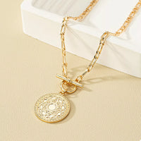 Chain Link Necklace with Vintage Coin Pendant displayed on a neutral background.