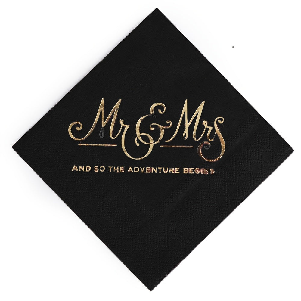 a black napkin with a gold foil lettering on it