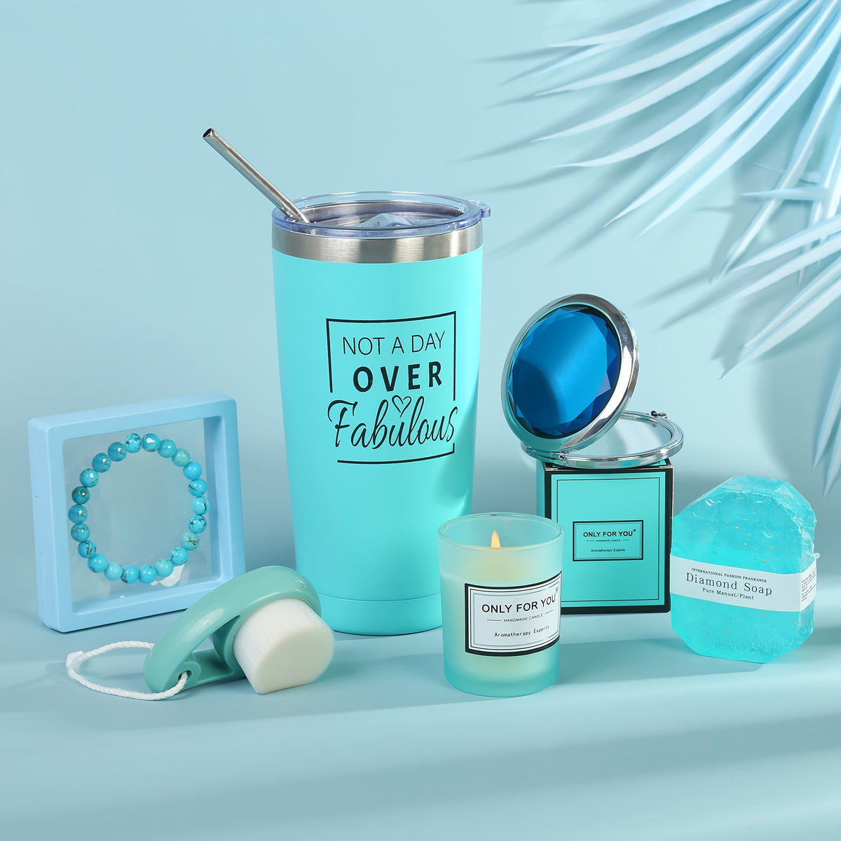 a blue travel mug next to a candle and other items