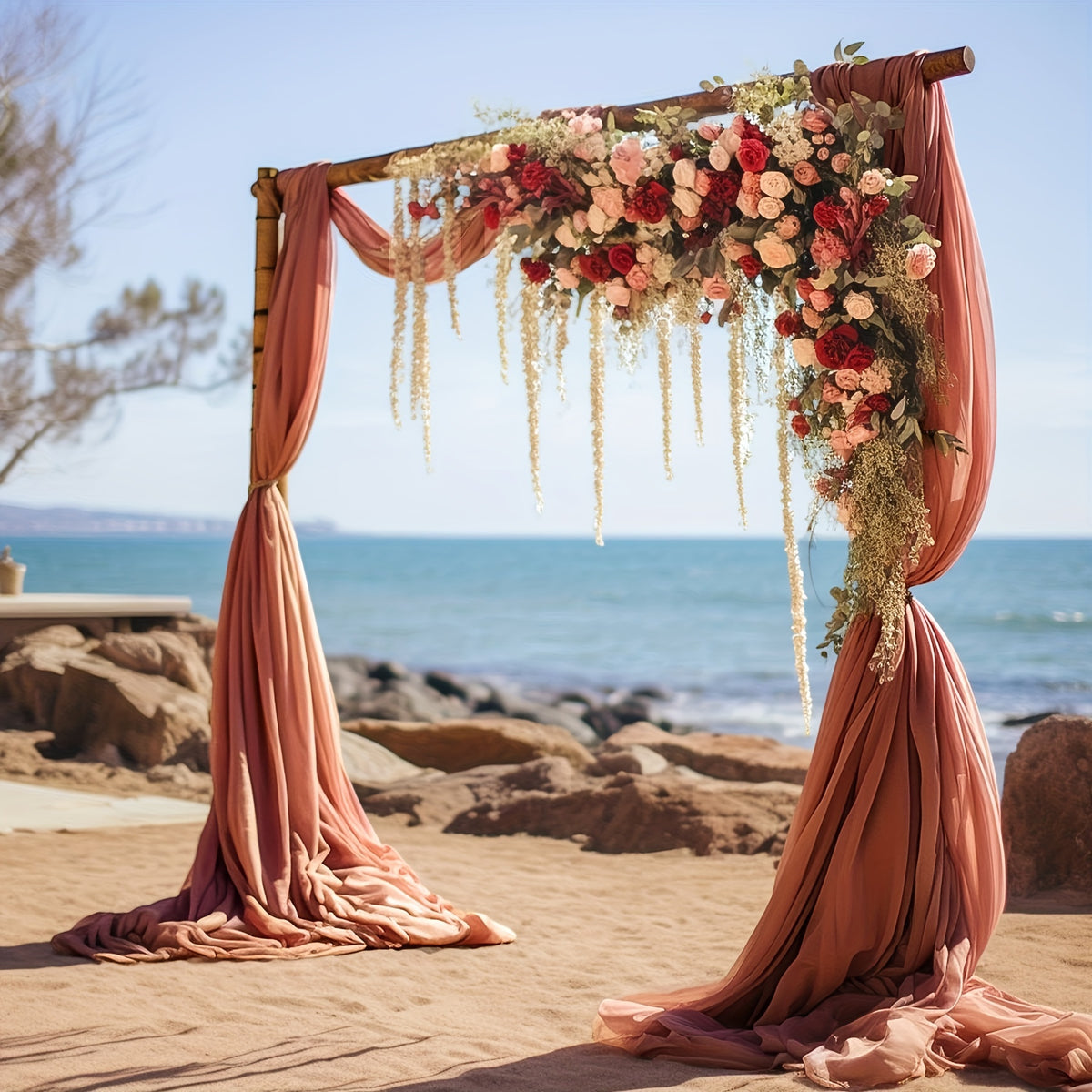 a wedding arch decorated with flowers on the beach