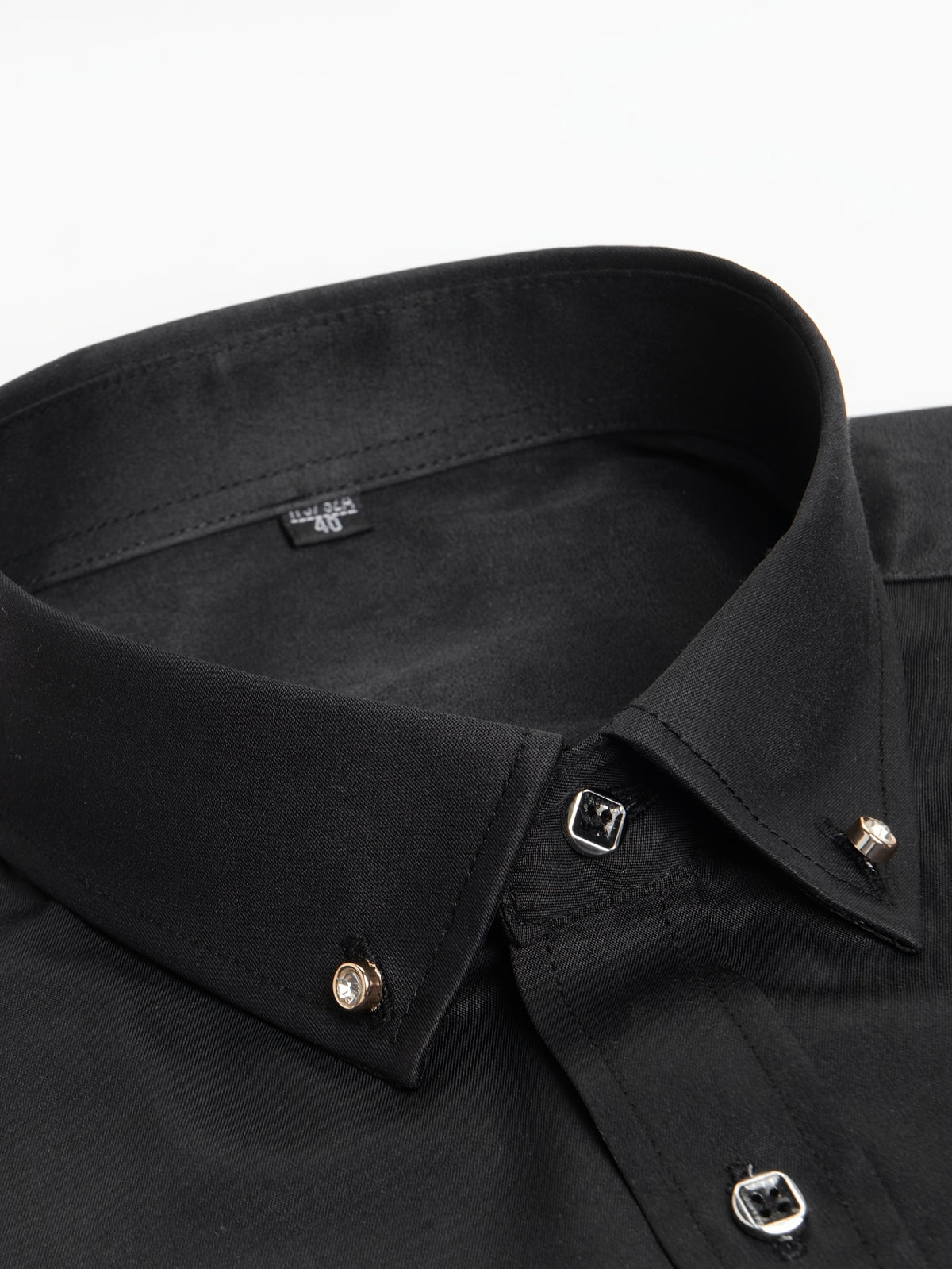 a close up of a black shirt on a white background